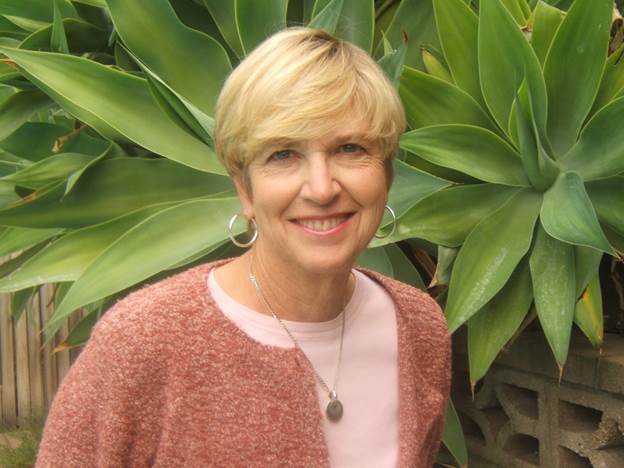 A person smiling in front of a plant

AI-generated content may be incorrect.